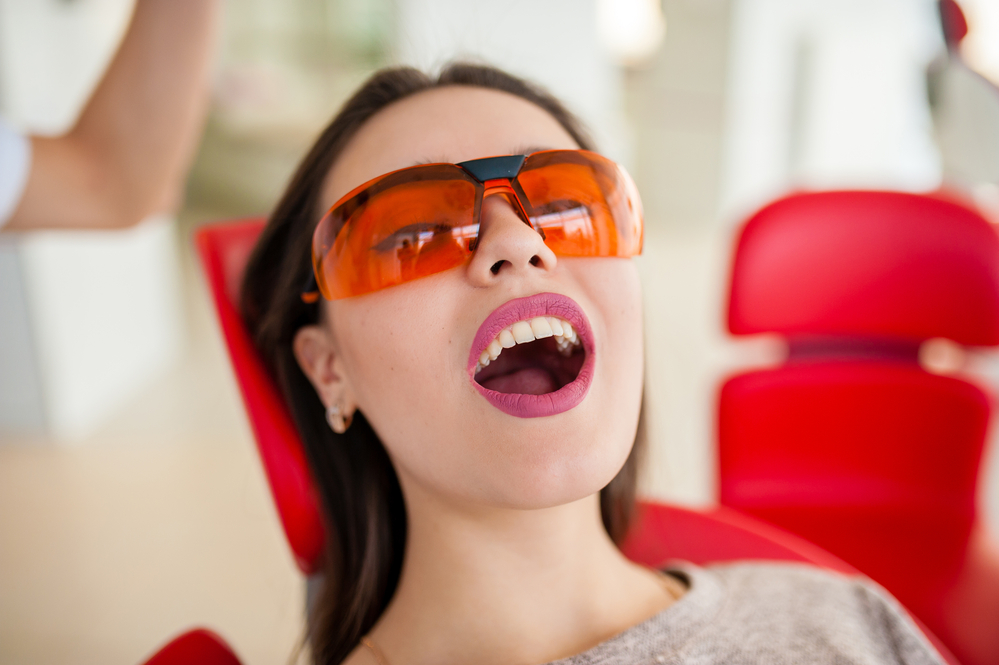 Dentistry, open mouth at the beautiful brunette girl.